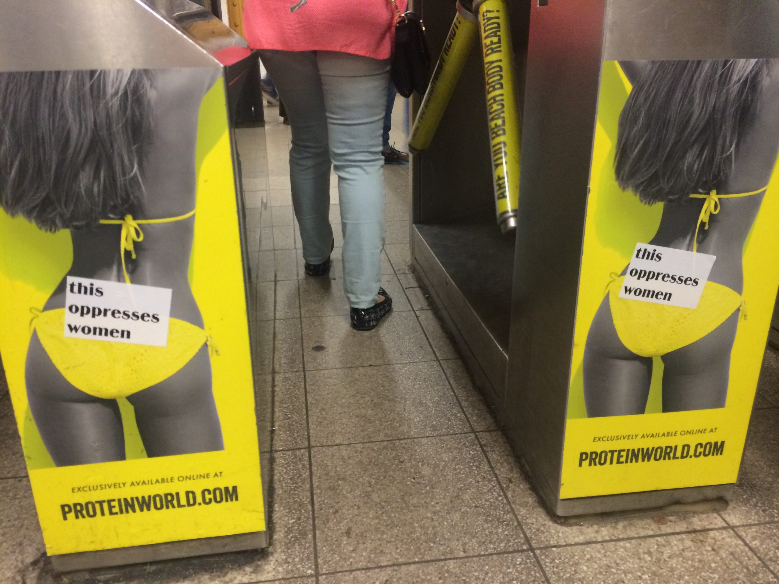 This Oppresses Women stickers on sexist ads